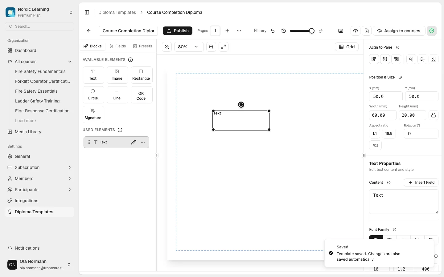 The editor after adding a text element and saving: the right-hand inspector shows the element's Position & Size and Text Properties, and a "Saved" confirmation is visible in the bottom right